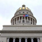 Capitol building dome with columns and a flag