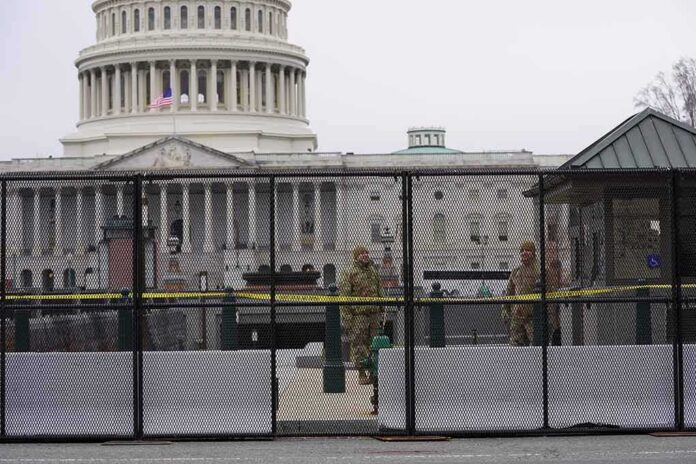 US Capitol behind security fence with guards