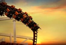 Roller Coaster Death Case Takes Troubling Turn roller coaster train rounding a curve at sunset