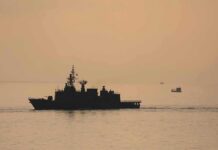 naval ship silhouette at sea during sunset