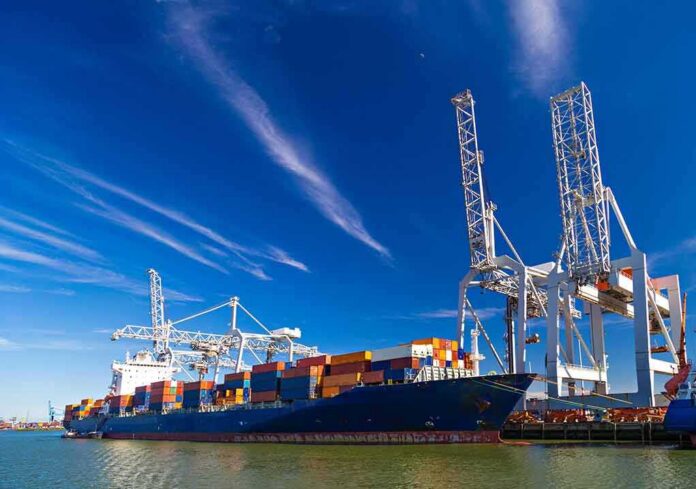 shutterstock_283990010 Container ship docked at port with cranes loading cargo