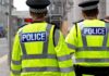 Fifty Police Leaders Have One Message for Westminster Two police officers in high-visibility jackets walking on a city street