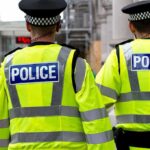 Fifty Police Leaders Have One Message for Westminster Two police officers in high-visibility jackets walking on a city street