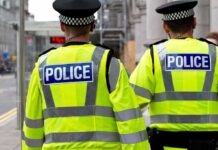 Fifty Police Leaders Have One Message for Westminster Two police officers in high-visibility jackets walking on a city street