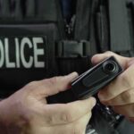 Police officer holding a body camera