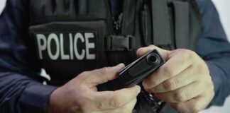 Police officer holding a body camera