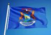 Viral Hype, Ballot Pain — Panic Inside DNC Michigan state flag waving on a flagpole