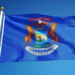 Michigan state flag waving on a flagpole