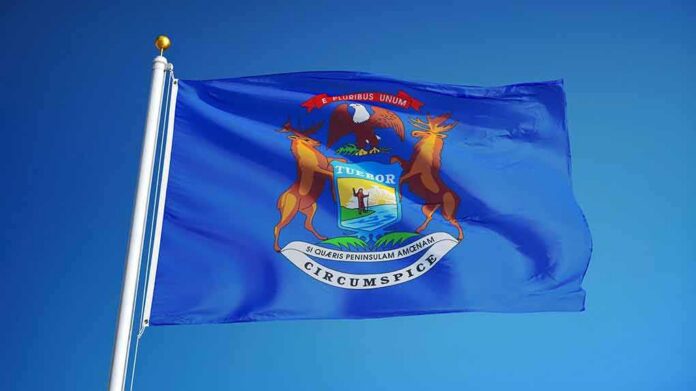 shutterstock_549470536 Michigan state flag waving on a flagpole
