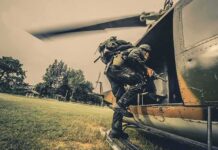Soldier boarding a helicopter during field operation
