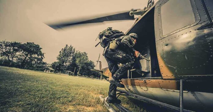 shutterstock_643981108 Soldier boarding a helicopter during field operation