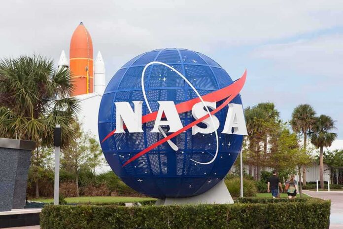 NASA globe sign at visitor center with space shuttle booster in background