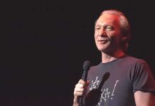 One Sweeping Religion Claim Got Shut Down comedian holding a microphone on stage