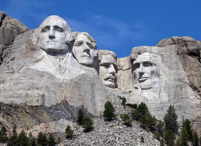 113115559 Mount Rushmore with four presidential faces carved in rock.