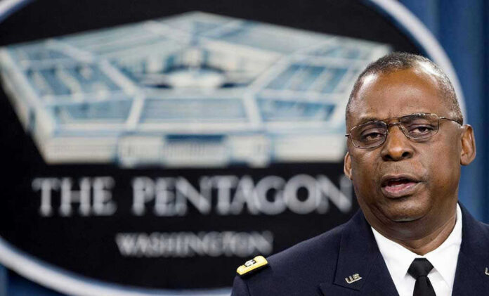 Lloyd Austin speaking at a podium in front of a Pentagon emblem
