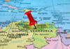Trump Reaches Deep Into Venezuela’s Oil Giant Red pin on Venezuela, South America map.