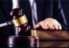 Demolition Threat Freezes Kennedy Center Judge's gavel striking block with hand on book in background