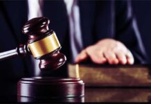 Demolition Threat Freezes Kennedy Center Judge's gavel striking block with hand on book in background