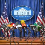 Blanche at Podium – What’s Trump Planning? Press microphones at a White House briefing podium