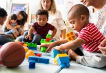 Are Mild Cases Flooding ADHD Rolls? Karyn Polito with toddlers building blocks on a play mat