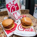Chicken sandwiches on a speckled countertop by a window