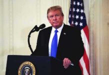 Stunning Cross-Party Vote Kills Impeachment man at podium with microphone and US flag