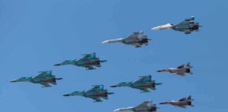 A formation of military jet fighters flying in a clear blue sky