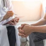 Doctor consulting a patient on a sofa
