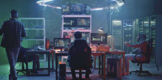 People working at computers in a dim server room
