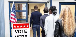 Voters standing in line at a polling place entrance