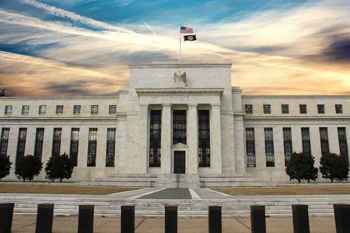 Neoclassical government building with American flag at sunset