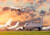 A Hidden Weakness Lurks Inside America’s Cockpits Passenger jets on airport tarmac with one aircraft landing at sunset
