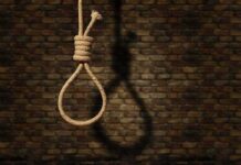 12 Sentenced to Death For Drug Ring Rope noose hanging against a brick wall
