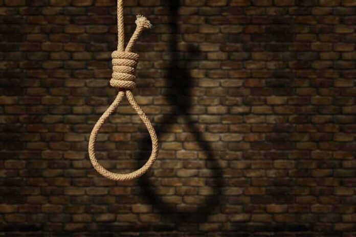 shutterstock_1793044216-1 Rope noose hanging against a brick wall