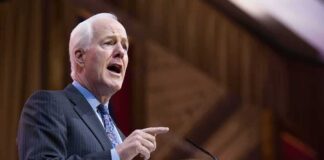 John Cornyn speaking at a podium