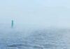The World’s Oil Lifeline Is Choking Again Green buoy in foggy sea