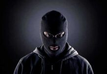 Person in a black ski mask facing forward