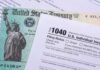 U.S. tax form 1040 beside a Treasury check