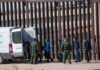 ICE Arrests Surge To A Stunning New Record Border agents escort a group near a tall fence and a patrol van