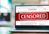 Laptop screen with a large censored banner