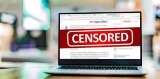 Laptop screen with a large censored banner