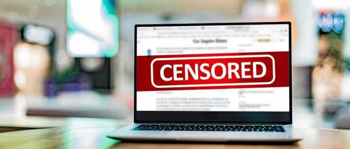 shutterstock_2090661886 Laptop screen with a large censored banner