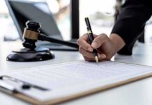 TRICARE Heist Funds Flashy Gold Cybertruck Hand signing legal document beside gavel and laptop