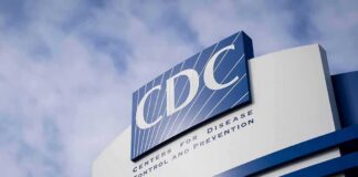 CDC headquarters sign against a cloudy sky
