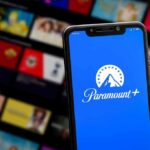Smartphone showing Paramount+ app on blue screen