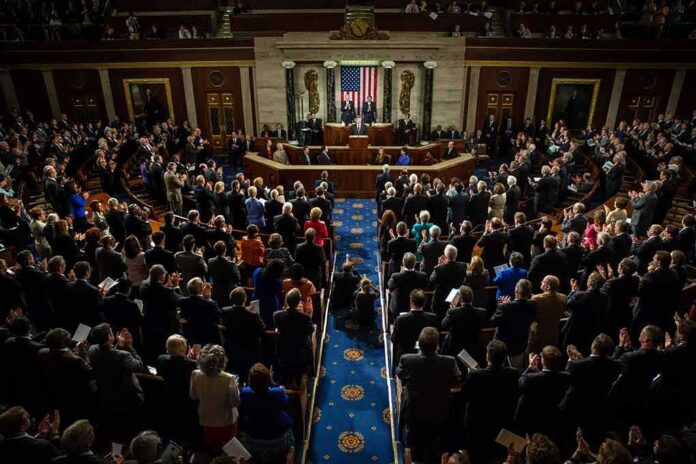 shutterstock_218485888 Legislative chamber audience stands and applauds