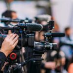 Historic Iranian Emblem Faces World Cup Controversy Video cameras on tripods at a media event