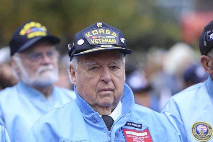Elderly veteran in blue jacket and cap at a ceremony