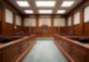Cop’s Lies Put Man in Prison For 6 Years Empty courtroom with wooden benches and judge's bench