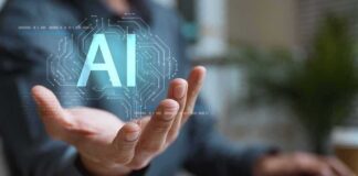 Hand holding glowing AI hologram